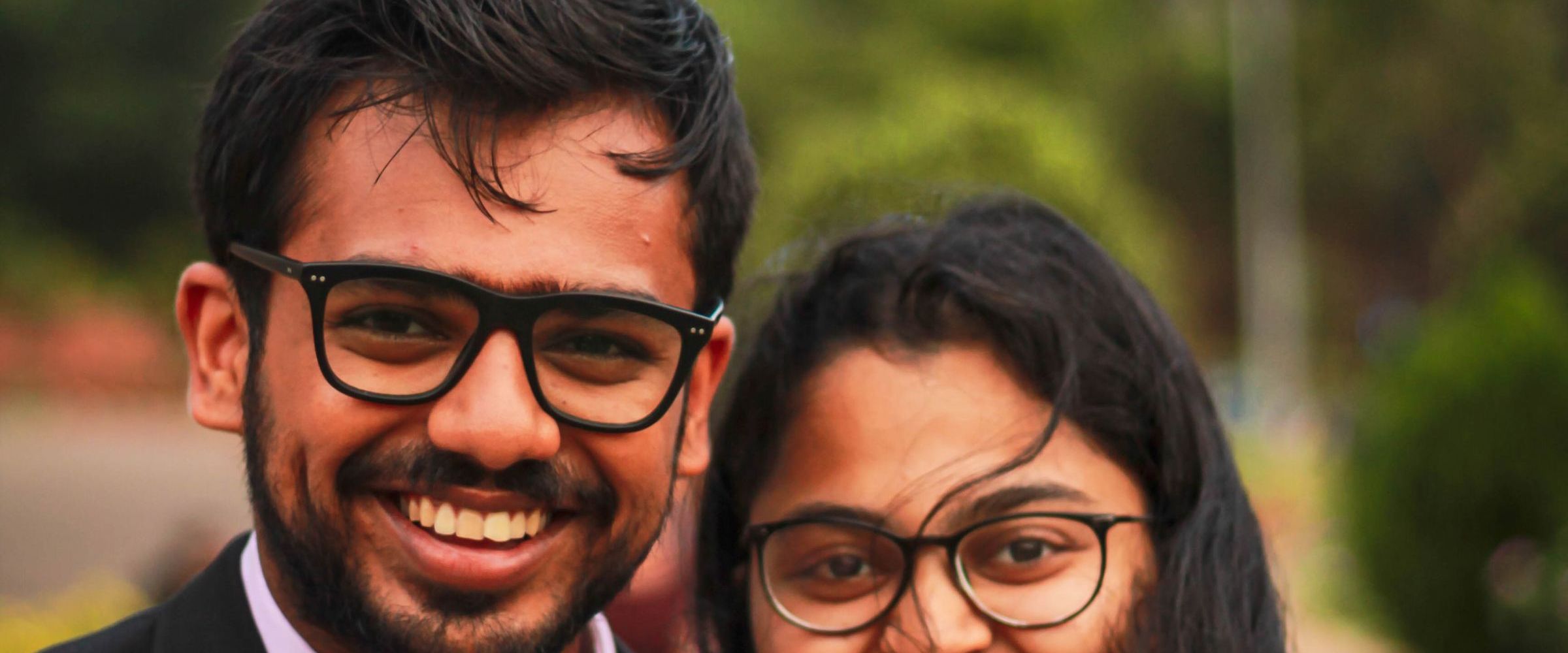 Two young Indian graduates smiling together